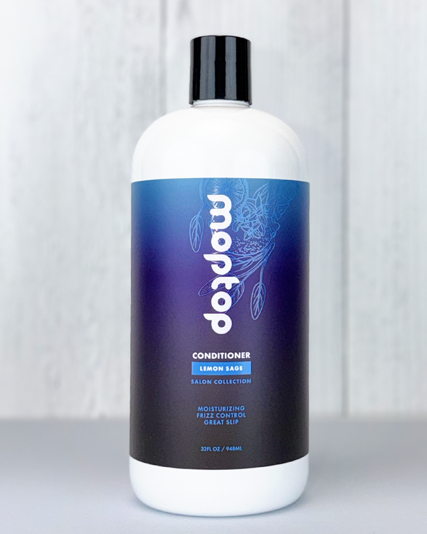 A 32 ounce bottle of Salon Conditioner against a white wood background