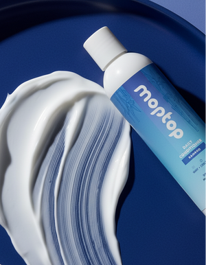 A Daily Conditioner Bottle next to a smear of its conditioner