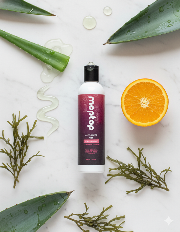 A bottle of Salon Anti Frizz Gel surrounded by aloe vera, an orange slice, gel, and seaweed