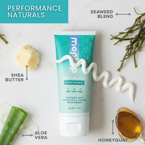 A Curly Hair Cream bottle surrounded by honeyquat, aloe vera, shea butter, and seaweed