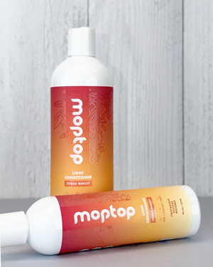 An 8 ounce and 16 ounce bottle of Light Conditioner next to each other